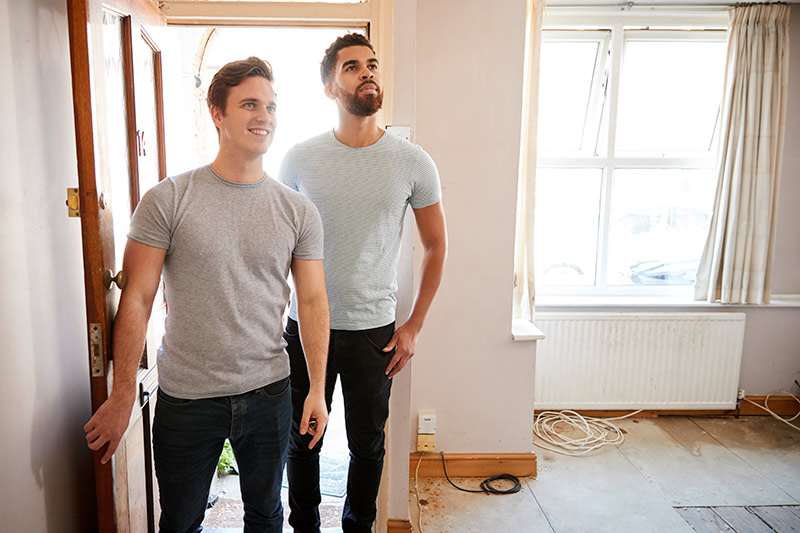 Couple opening front door of new home