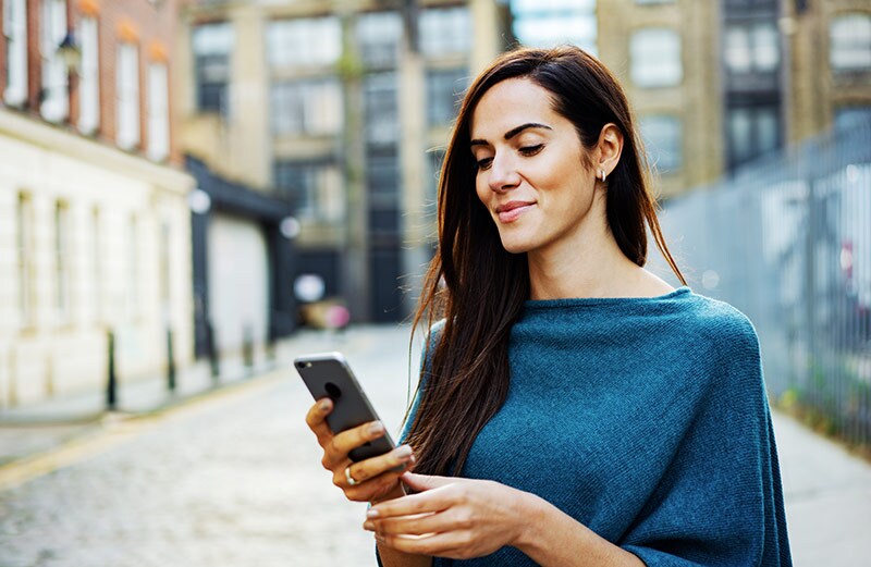 Woman using smart phone outside