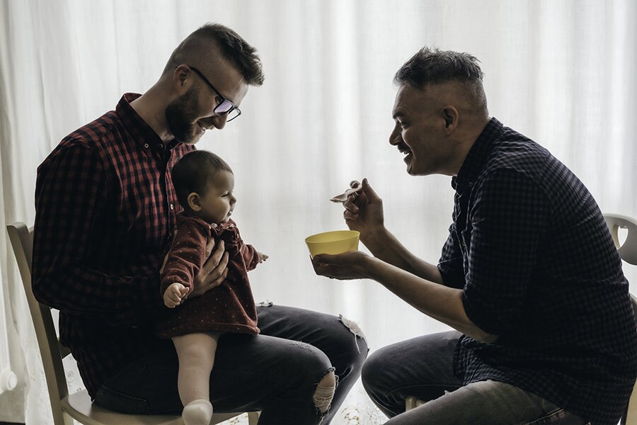 A couple feeds their baby