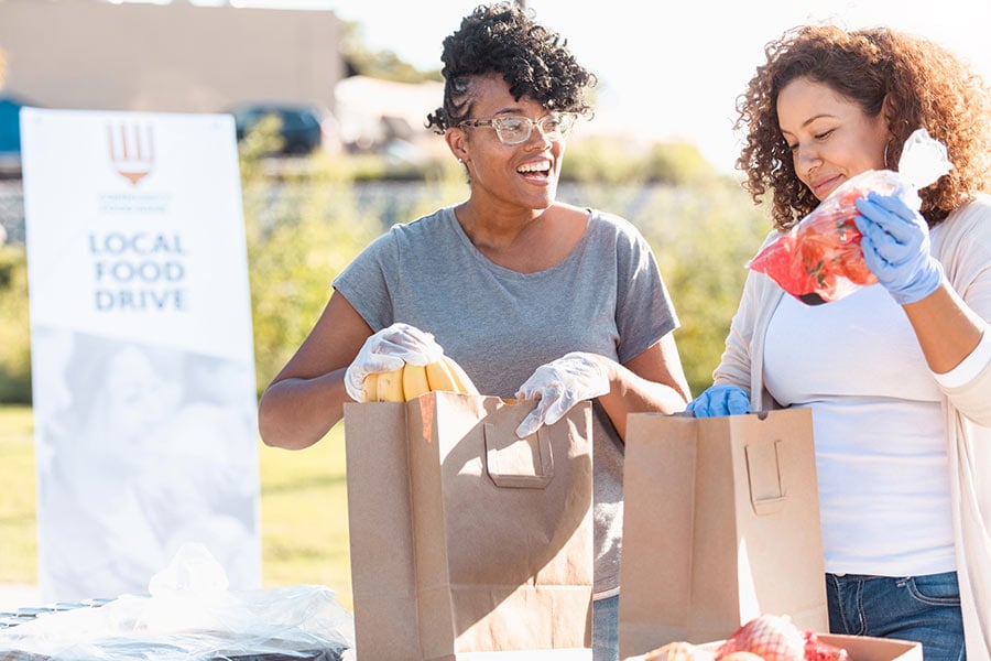 A business owner participates in a local food drive