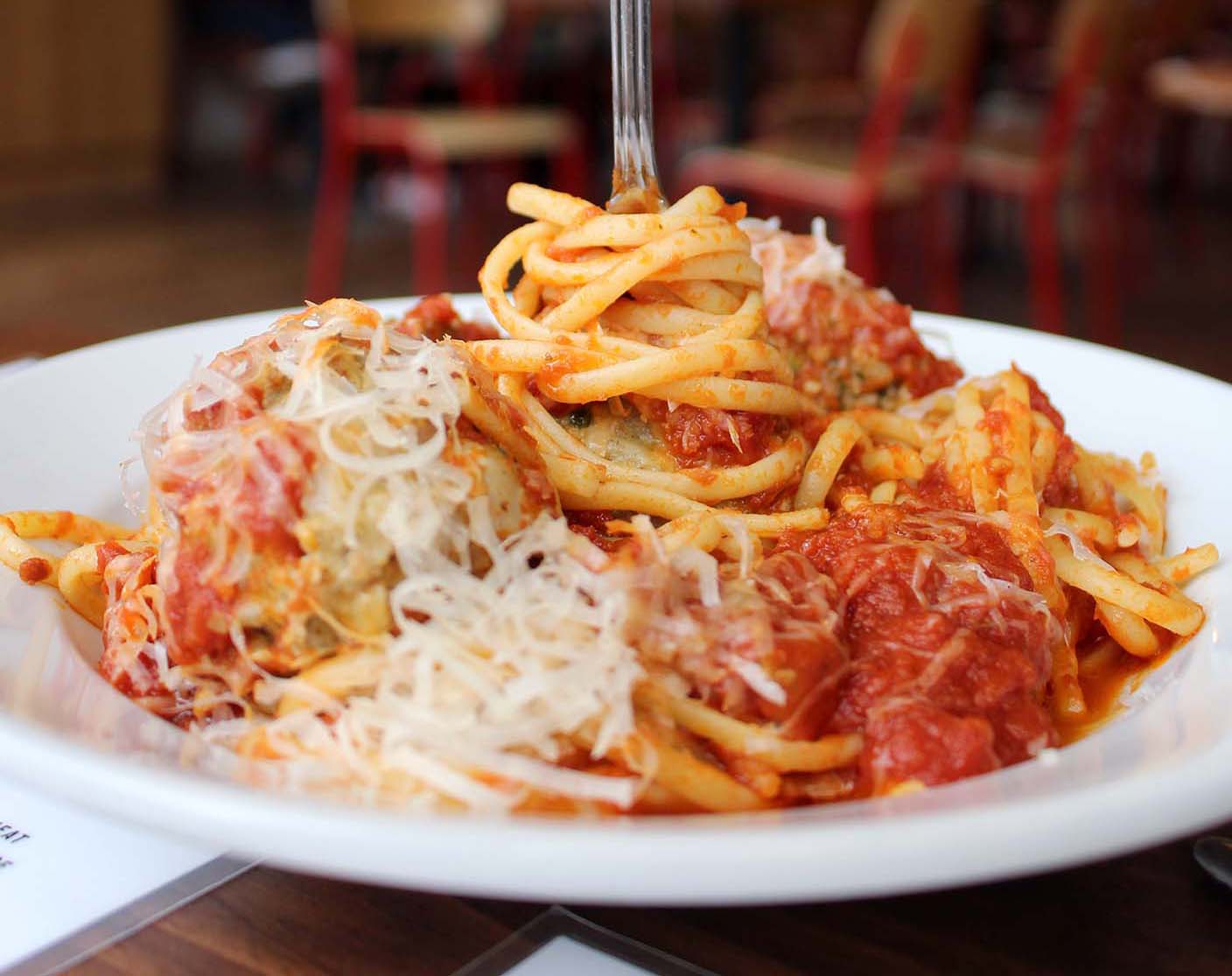plate of spaghetti and meatballs with fork sticking up