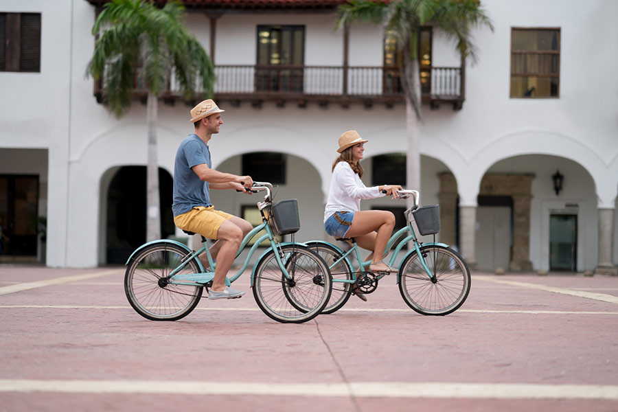 A couple ride bikes in Cartagena, Colombia