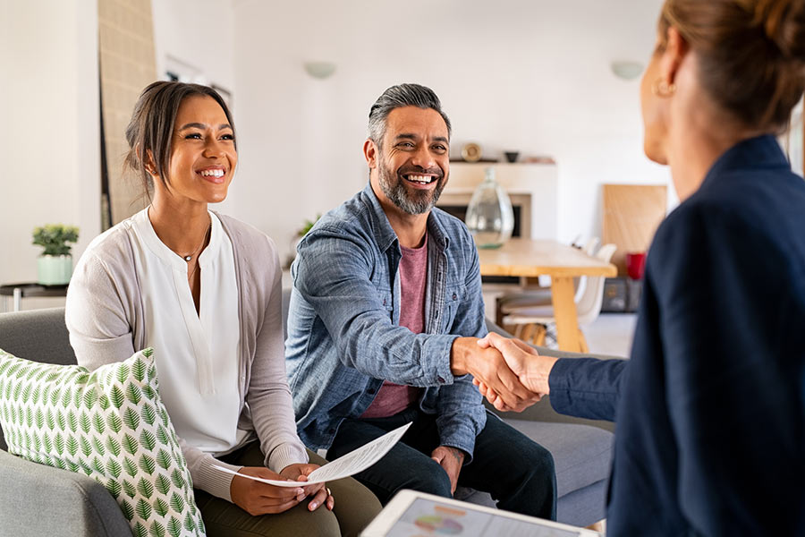 A couple meets with a financial advisor in their home