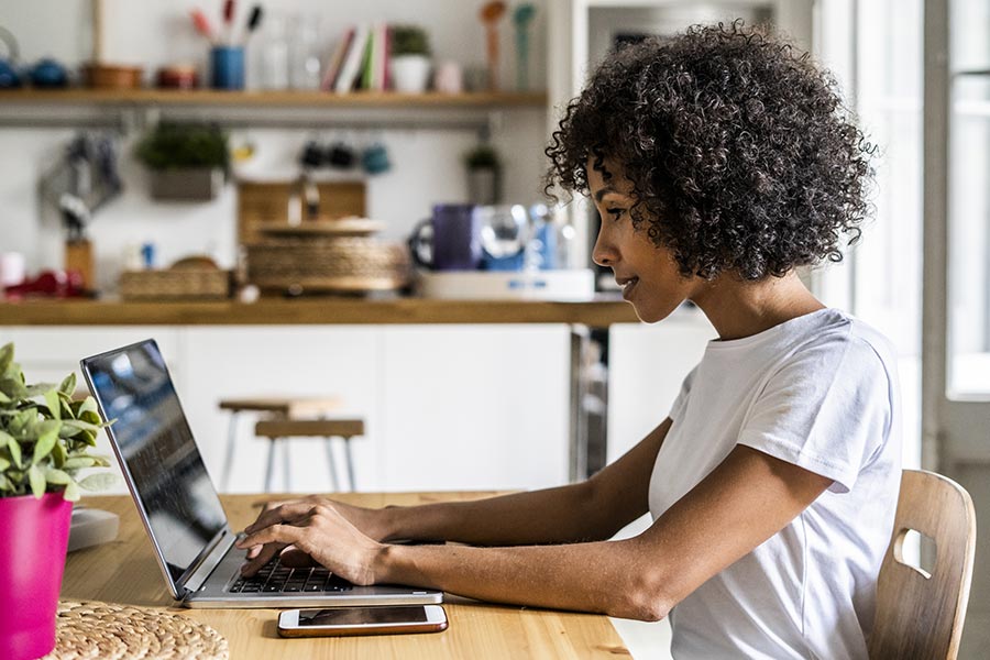 A woman uses her laptop to invest