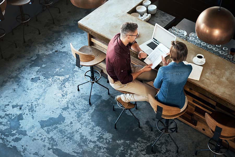 Two restaurant owners review paperwork