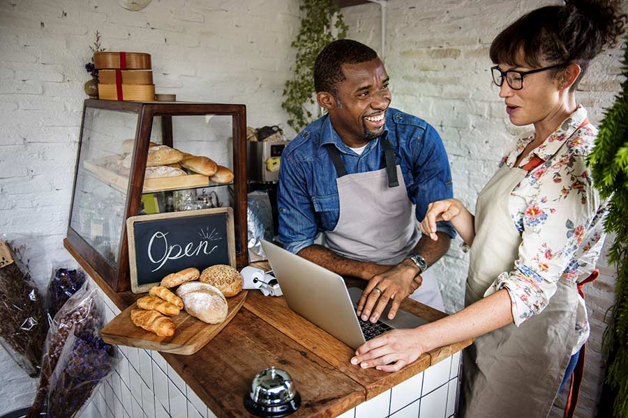 Bakery owners review billing on their laptop