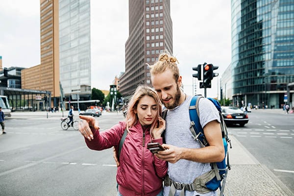 couple referring to mobile device for directions in an urban area
