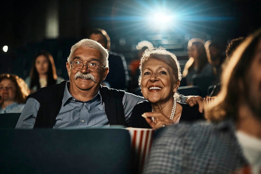 older couple enjoying a movie